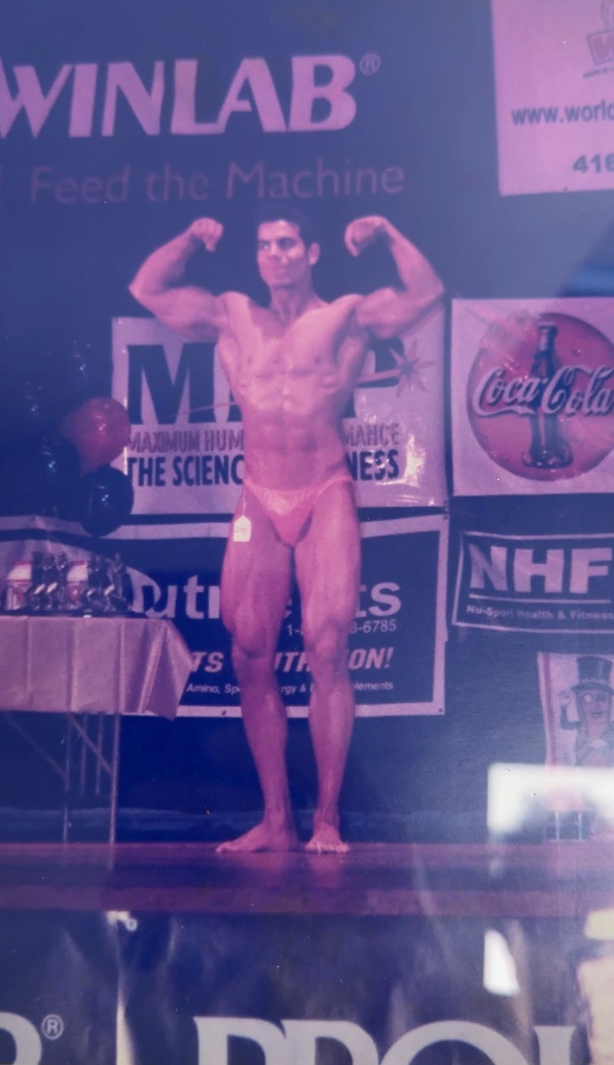 Alex Savva on stage at his first natural bodybuilding win, age 20